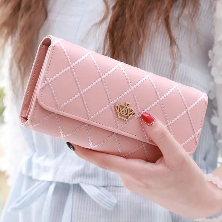 Lifestyle shot of a woman holding the elegant argyle pattern trifold wallet.