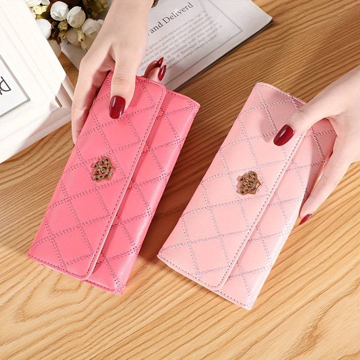 Open trifold women's wallet revealing all card slots and inner organizational pockets.