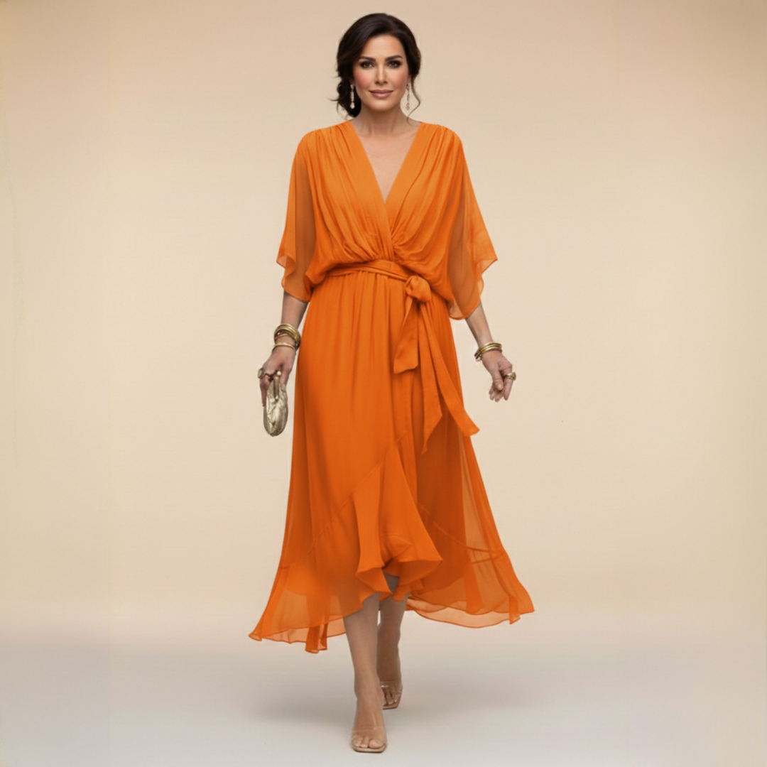 Textile and hem detail of women's elegant belted midi cocktail dress