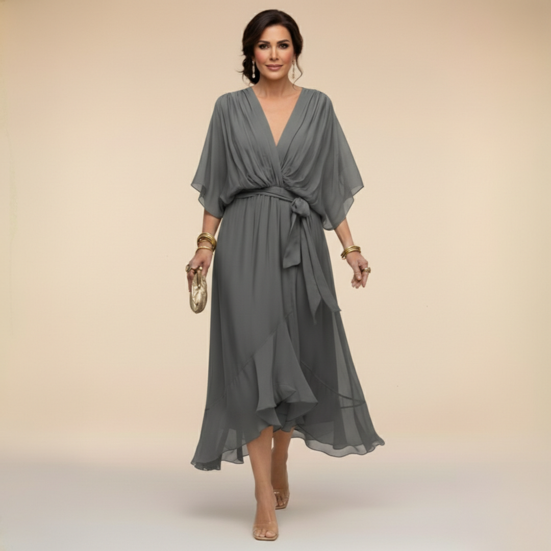 Side view of women's belted cocktail dress showing flattering midi length fit