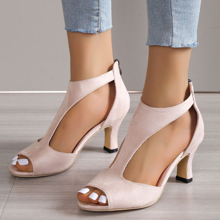 Side profile of pink open toe heeled sandals showing heel height