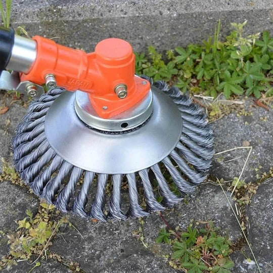 Steel wire weed trimmer head mounted on an electric trimmer clearing pavement
