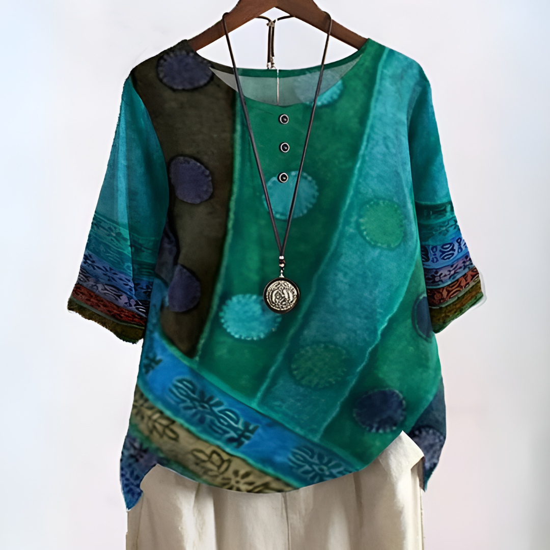 Heloise women's green boho print relaxed fit blouse hanging on display