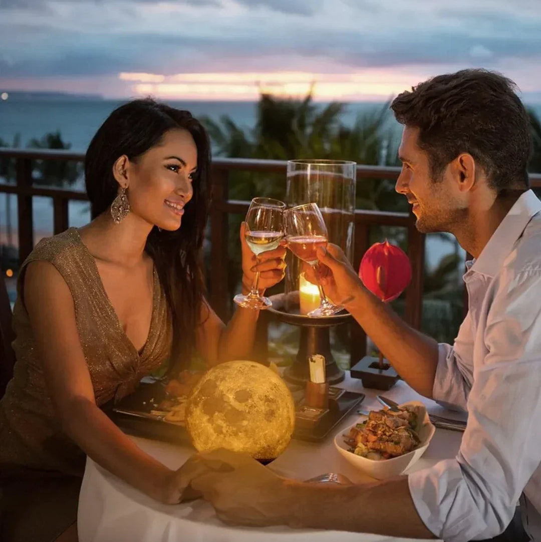 Couple enjoying dinner next to the glowing moon lamp