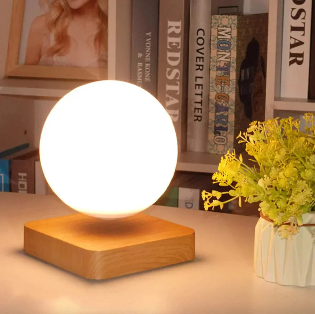 Floating moon lamp hovering above a wooden base