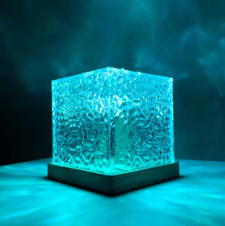 Close-up of the glowing crystal cube Northern Lights lamp on a tabletop