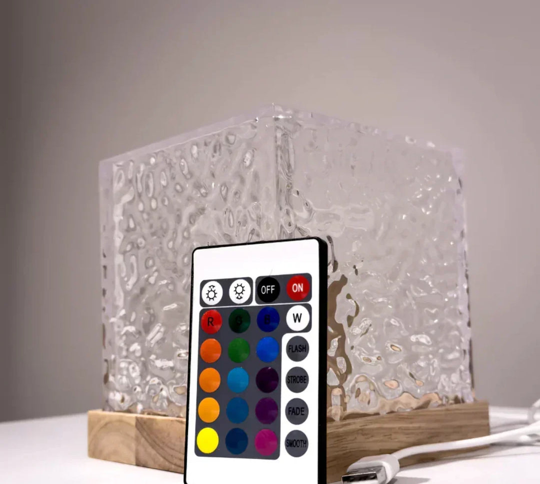 LED mood lamp displayed alongside its wireless remote control and USB cable
