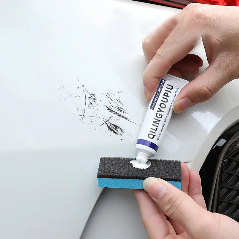 Applying car scratch remover cream with a sponge