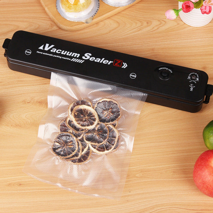Close-up of automatic vacuum sealer appliance operating with a textured sealing pouch.