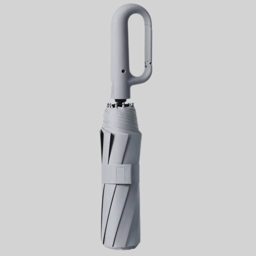 Auto-lock mechanism close-up on ergonomic handle of travel umbrella