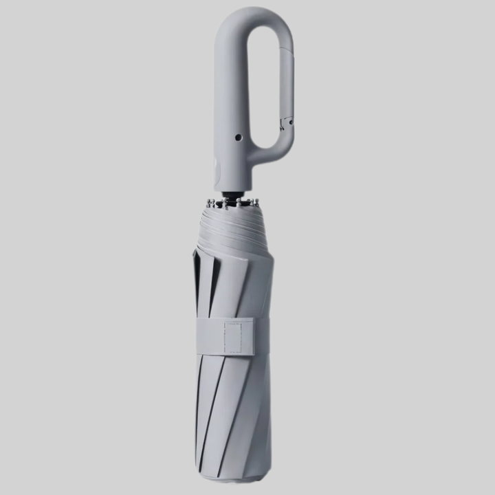 Auto-lock mechanism close-up on ergonomic handle of travel umbrella