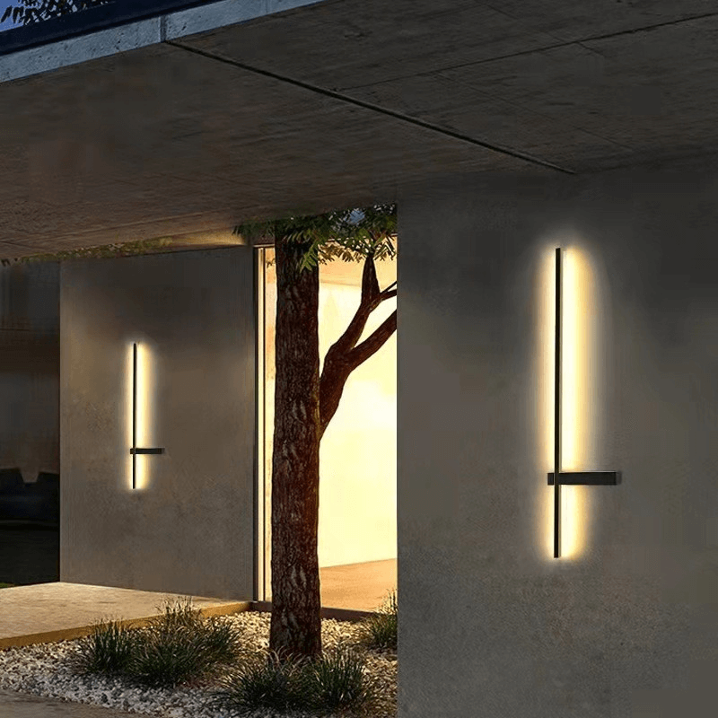 Sleek column LED wall lamps illuminating an exterior concrete entrance