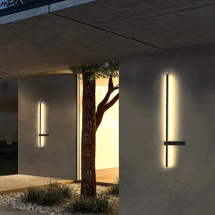 Sleek column LED wall lamps illuminating an exterior concrete entrance