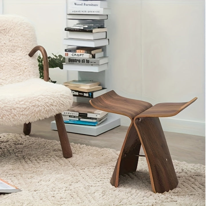Close-up of the curved solid wood grain on the designer butterfly stool