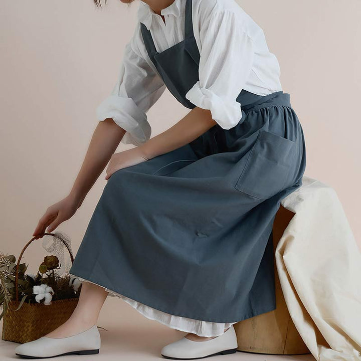Unisex pink waterproof baking apron worn by a home chef in the kitchen