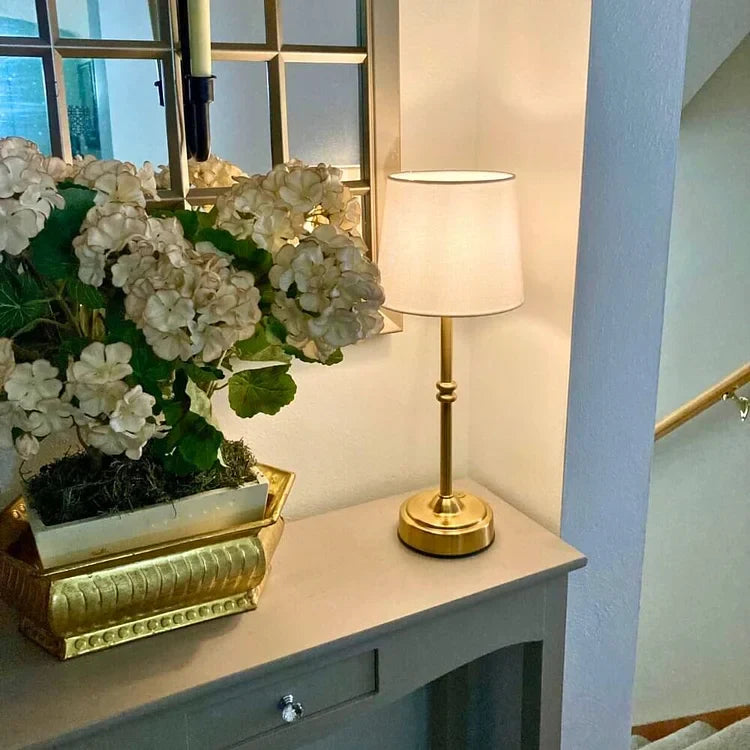 Gold finish vintage battery operated table lamp adding elegance to living room decor