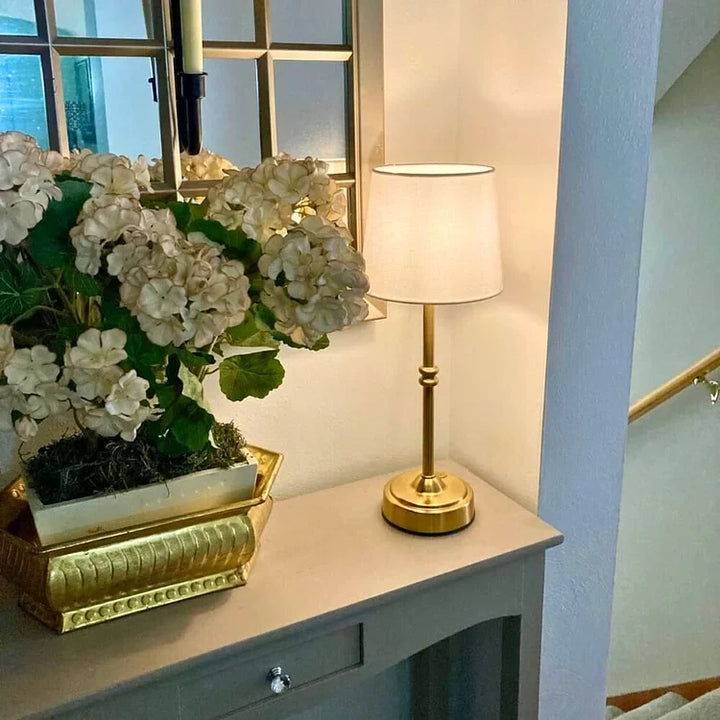 Gold finish vintage battery operated table lamp adding elegance to living room decor