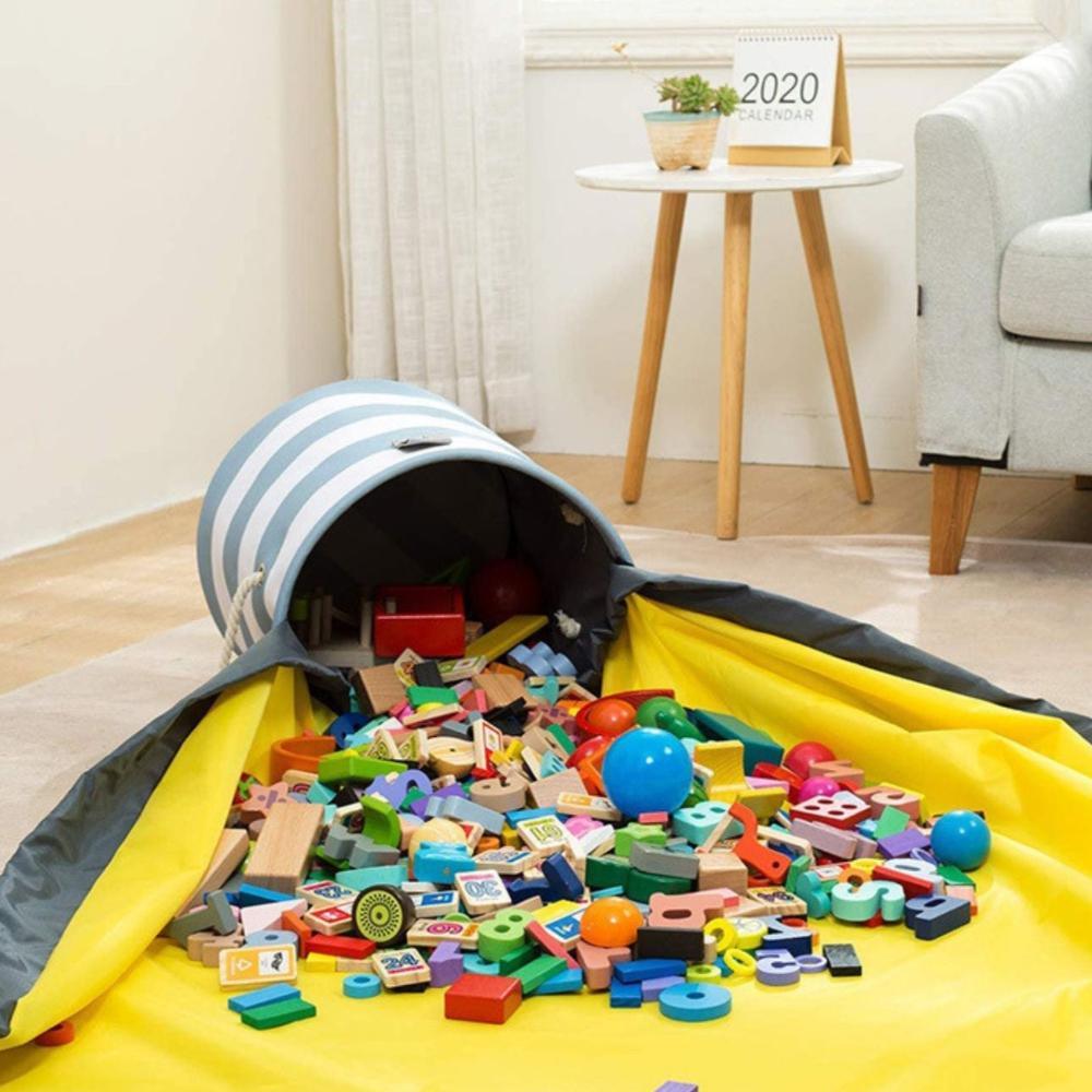 Blue and white striped toy storage basket with yellow play mat spread out on a living room floor