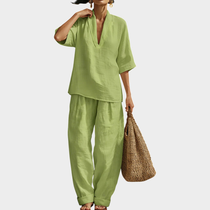 Front view of a woman modeling the green two-piece lounge set with half sleeves and V-neckline.