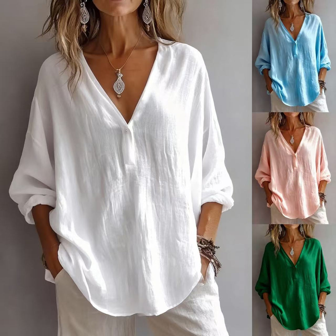 Woman wearing a casual loose white long-sleeve top with V-neck detail