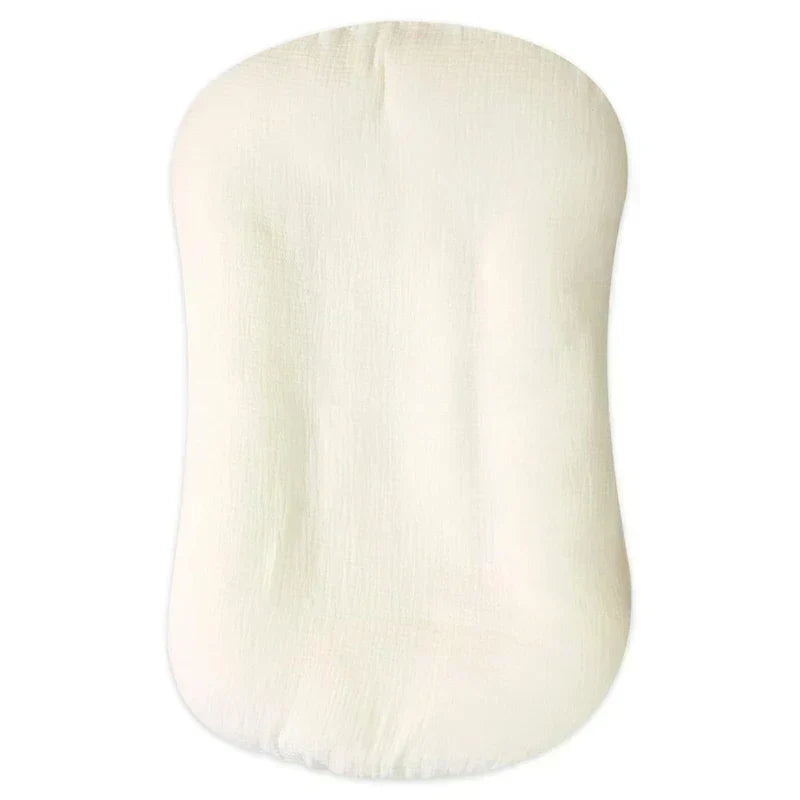 Charming nursery essential baby lounger styled on a soft rug