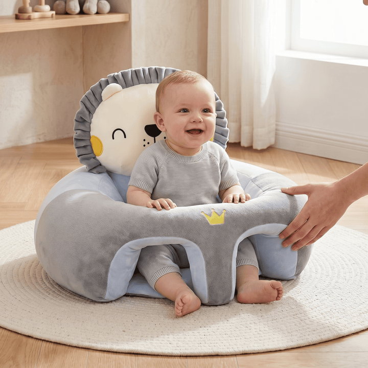 Happy baby sitting comfortably in a blue and grey Little Lion support seat