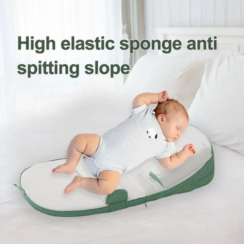 Green baby wedge pillow providing safe side sleeping support in a crib