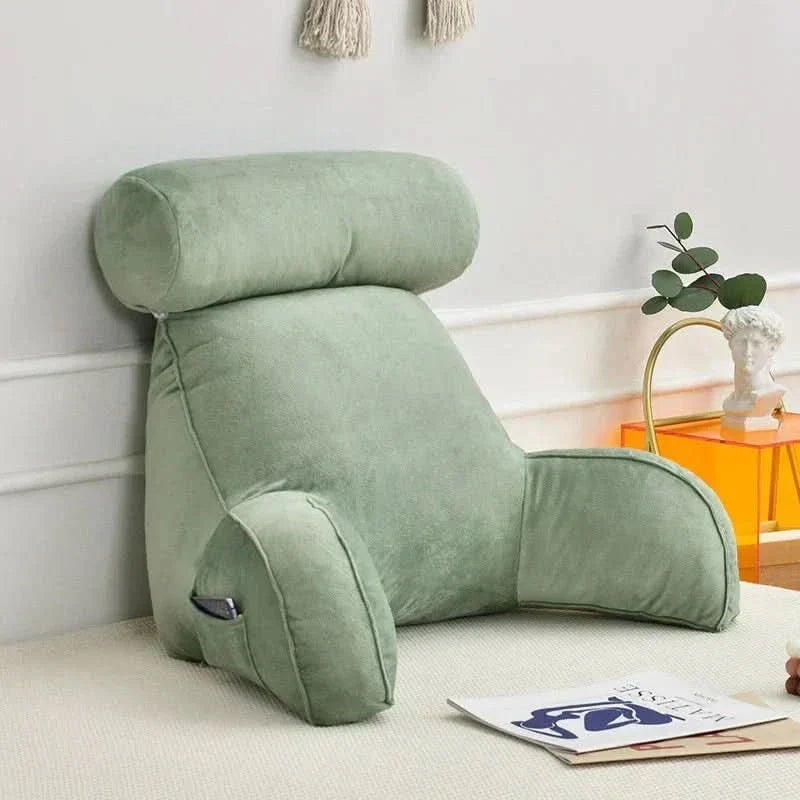 Cozy unisex lounging pillow with armrests positioned on a bed for daily comfort