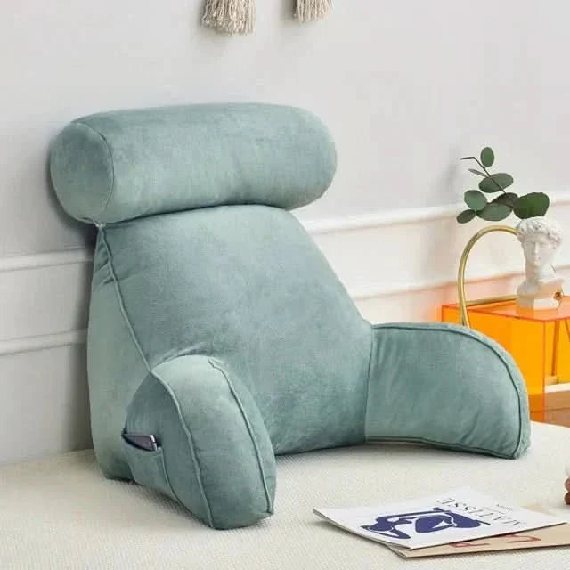 Side angle of ergonomic reading pillow highlighting supportive back and arm structure