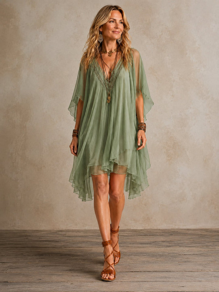 Close-up of the V-neckline and fabric texture on the green women's mini dress