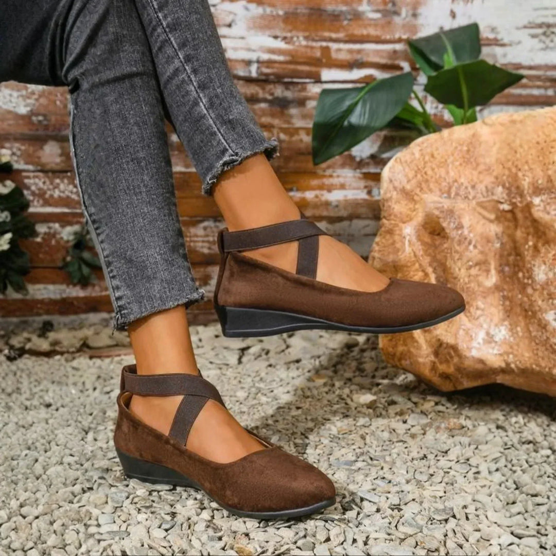 Brown women's closed wedge ballet flats styled with jeans