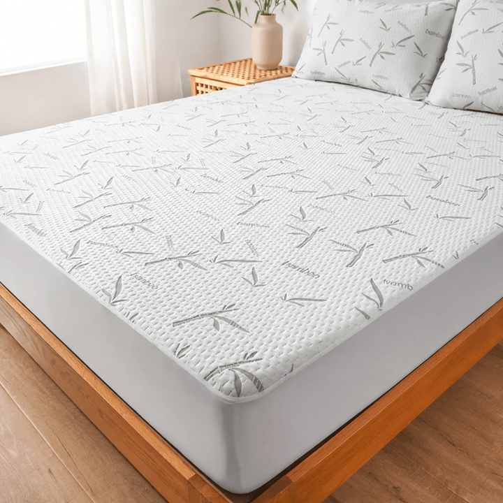 Close-up view of the adjustable cooling sheet with pattern on a wooden bed frame