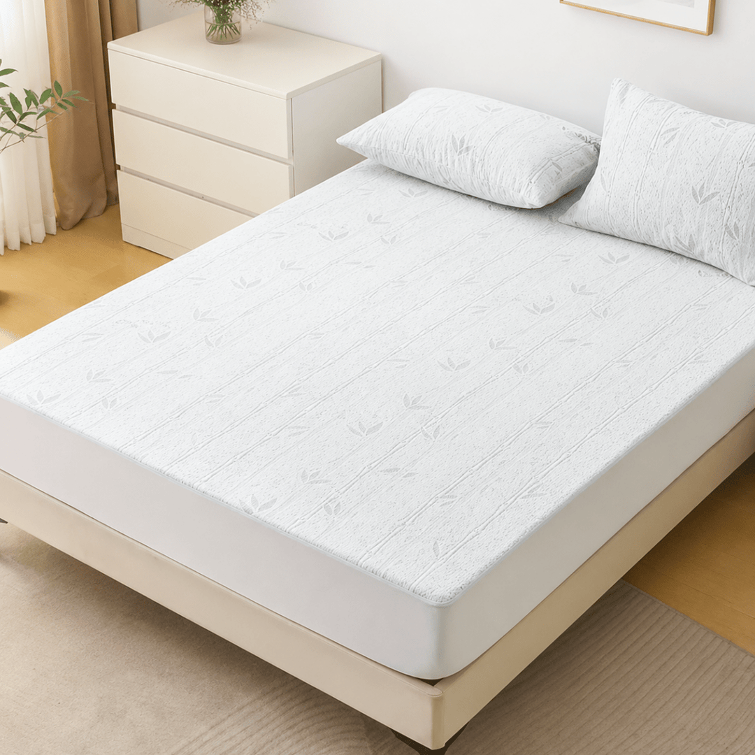 Full view of the cooling fitted sheet on a queen size mattress with matching pillows