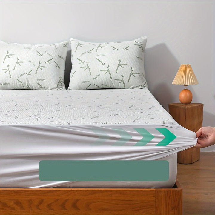 Full view of a neatly made bed featuring the breathable bamboo mattress protector and matching pillows.