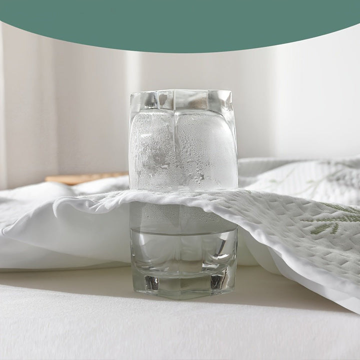 Demonstration of the cooling and moisture-wicking properties of the mattress protector with a chilled glass.