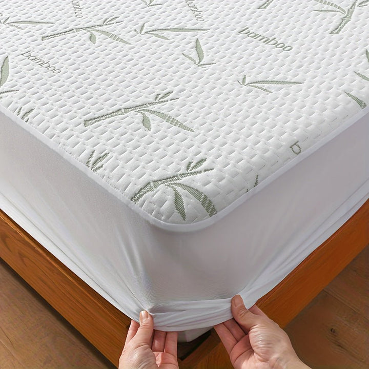 Close-up view of the textured bamboo mattress protector being fitted onto a corner of a bed.