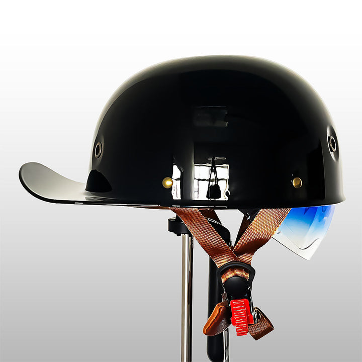 Glossy black baseball cap style motorcycle helmet mounted on a stand