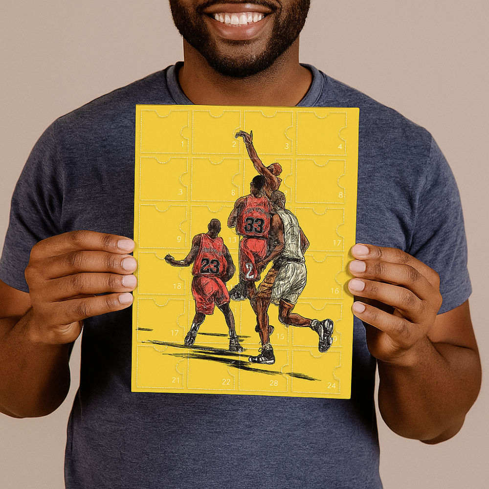 Man smiling while holding up the yellow basketball advent calendar box