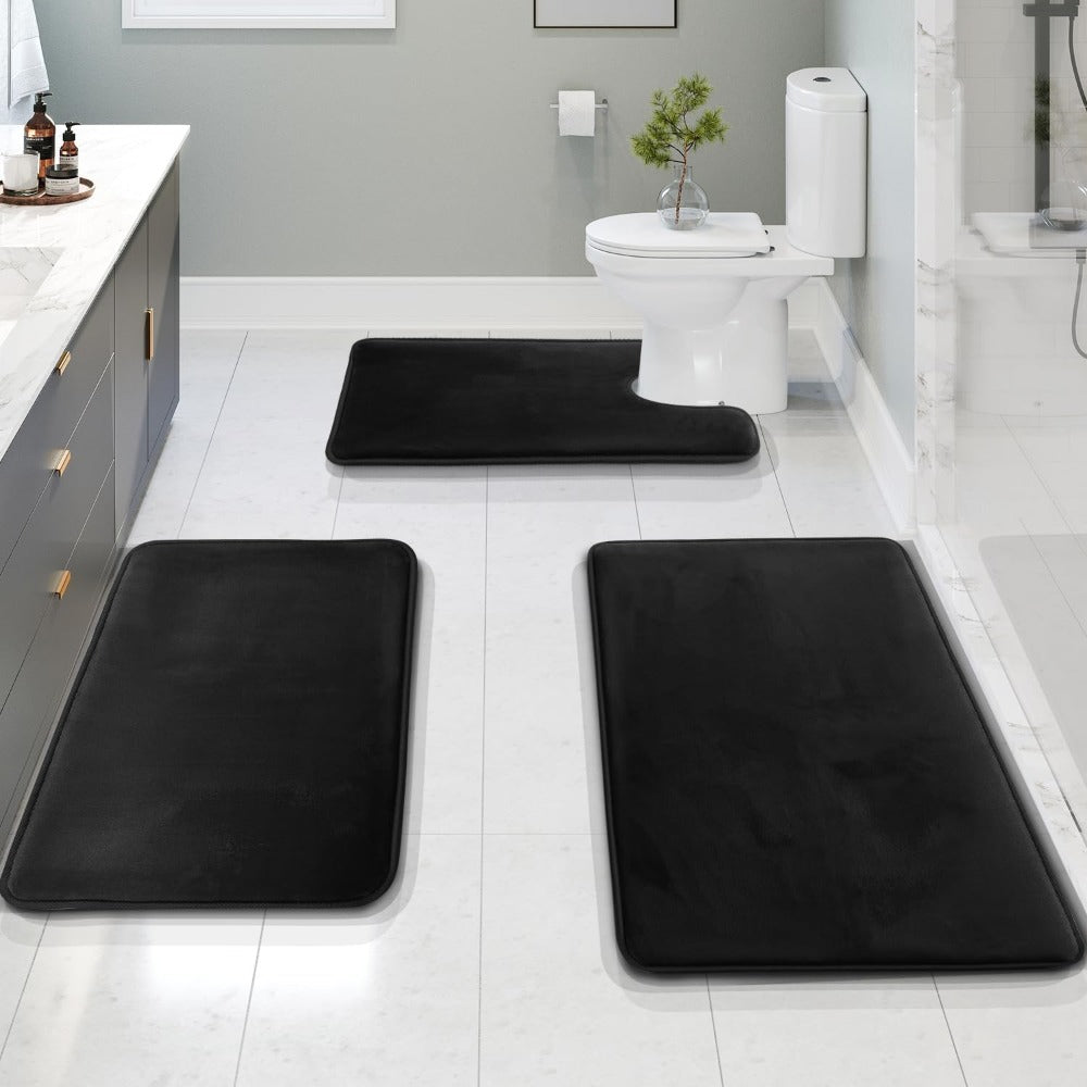 Black 3-piece memory foam bathroom mat set displayed in a modern bathroom