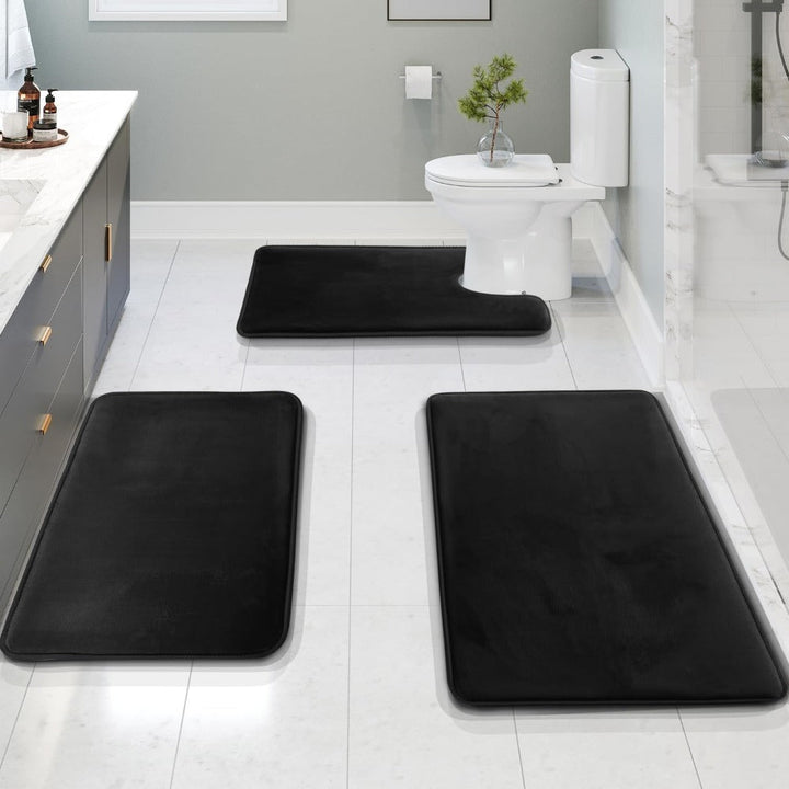 Black 3-piece memory foam bathroom mat set displayed in a modern bathroom