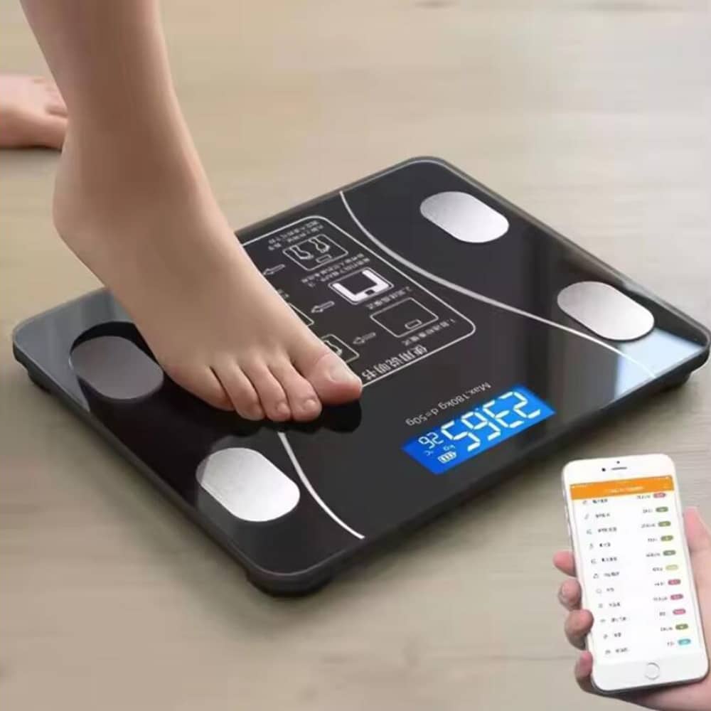 Person standing on a black smart bathroom scale with smartphone displaying health app data