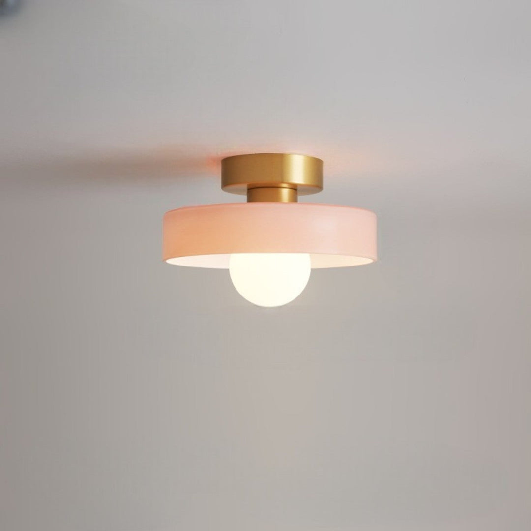 Designer living room lighting showcasing a minimalist brass ceiling lamp