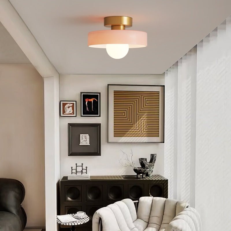 Minimalist Bauhaus ceiling lamp with spherical light glowing warmly