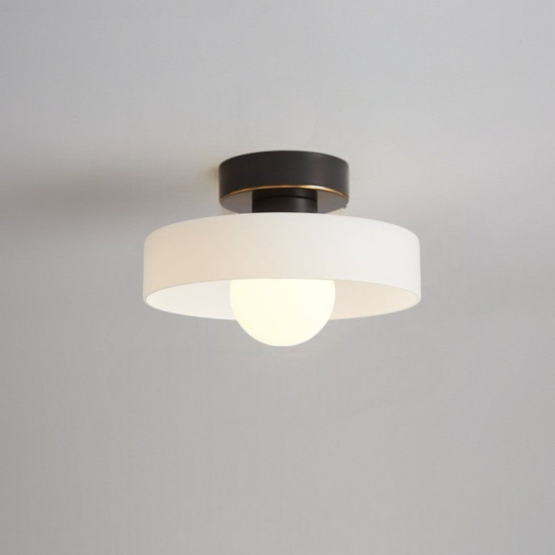 Close up view of the black and white minimalist Bauhaus ceiling lamp mounted on a ceiling