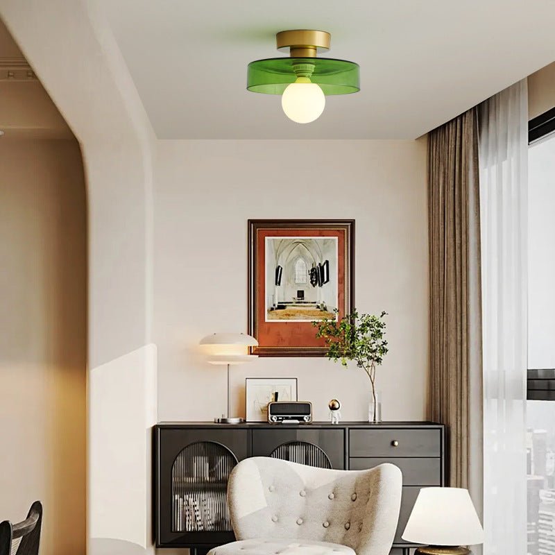 Elegant living room interior featuring the gold and green Bauhaus ceiling lamp providing warm light