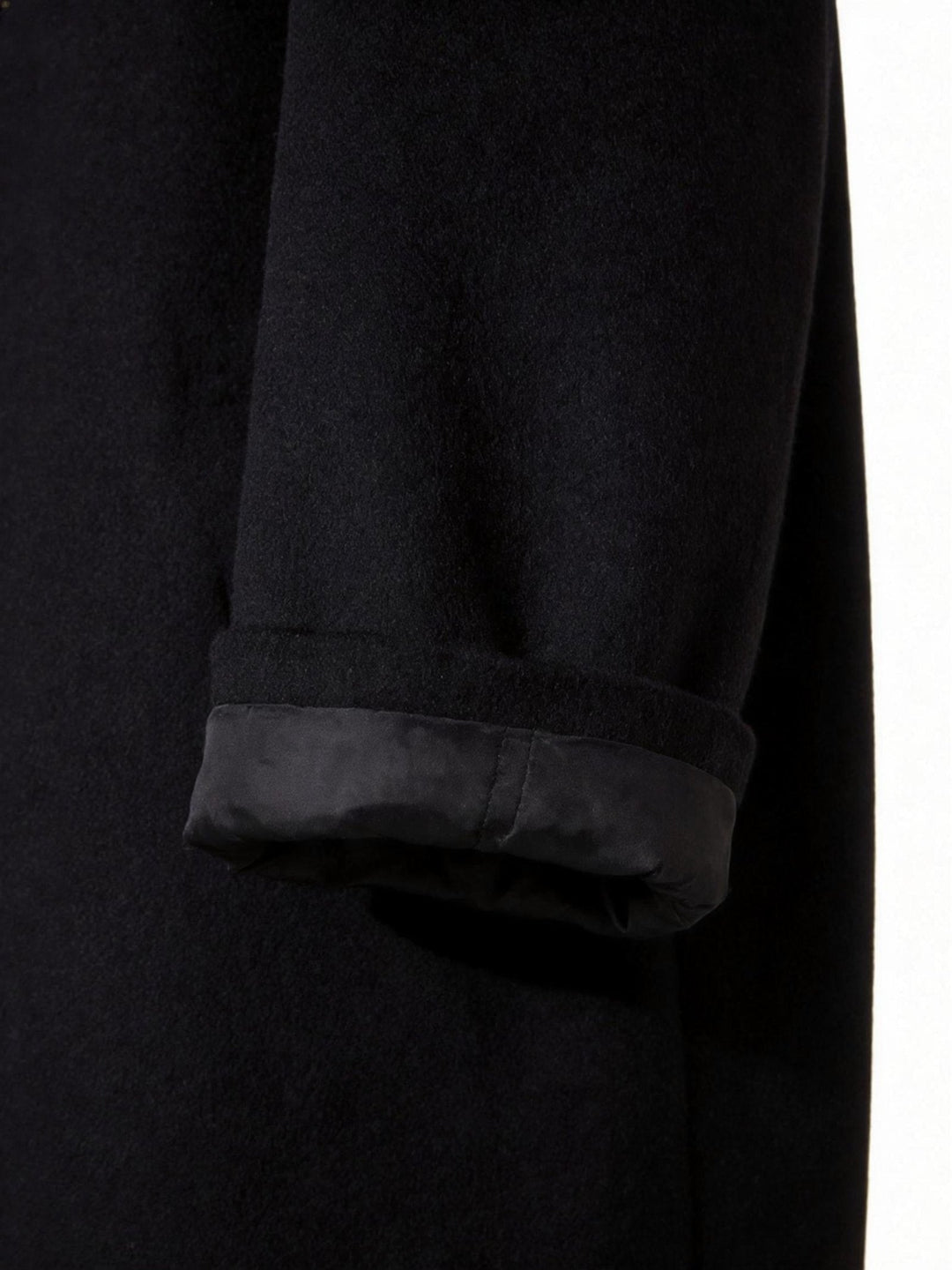 Interior lining detail of the men's long trench coat showing high-quality stitching.