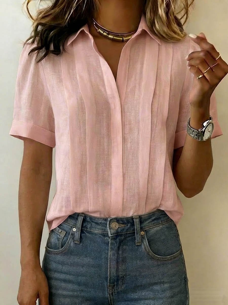 Woman wearing pink short-sleeve collared blouse with denim jeans