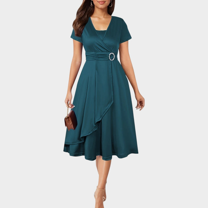 Close up of rhinestone waist accent on short sleeve wrap midi evening dress