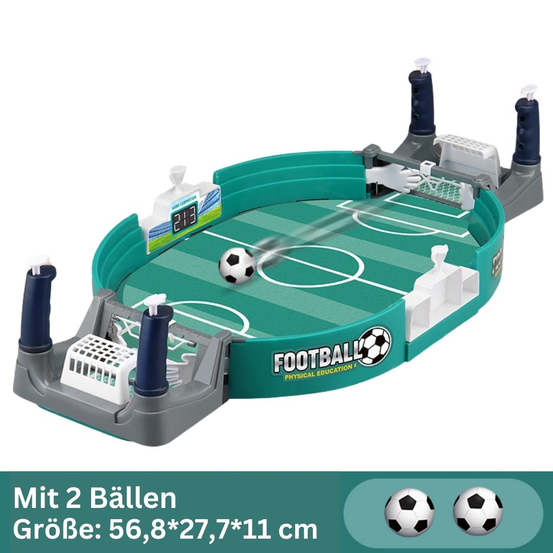 Kids playing with a mini table football game set in a living room setting