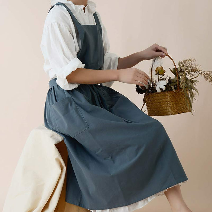 Blue waterproof kitchen apron showing adjustable neck strap and waist ties